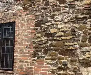 Brick and stone wall detail showcasing restoration potential for property maintenance.