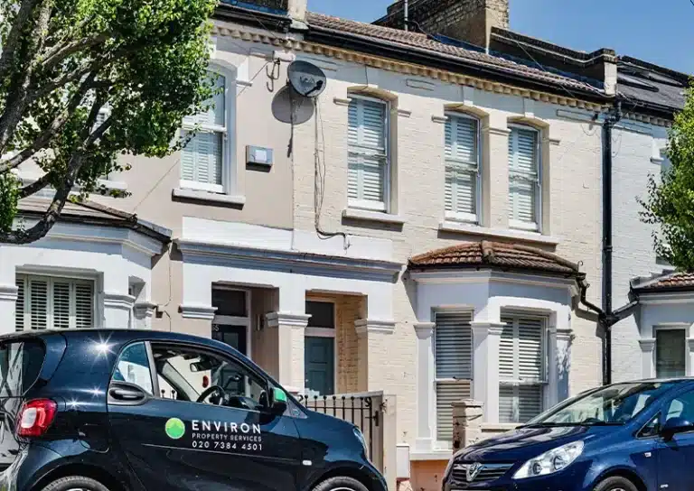 Victorian house exterior with Environ Property Services vehicle parked in front, showcasing the blend of historic architecture and modern restoration.