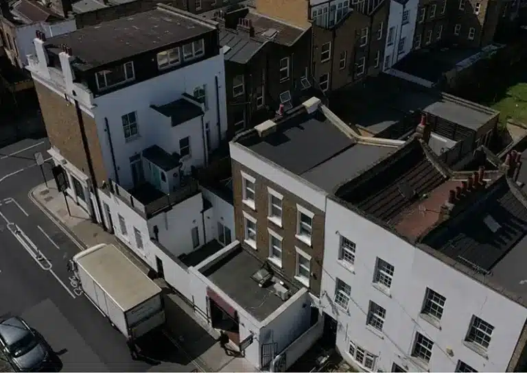 Aerial view of London buildings showing rooftops and adjacent streets, illustrating the area for drone roof survey services by Environ Restoration Services.