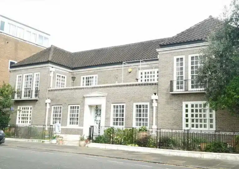 Edwardian-style property with decorative brick facade, multiple windows, and balcony, showcasing restoration potential for period homes in London.