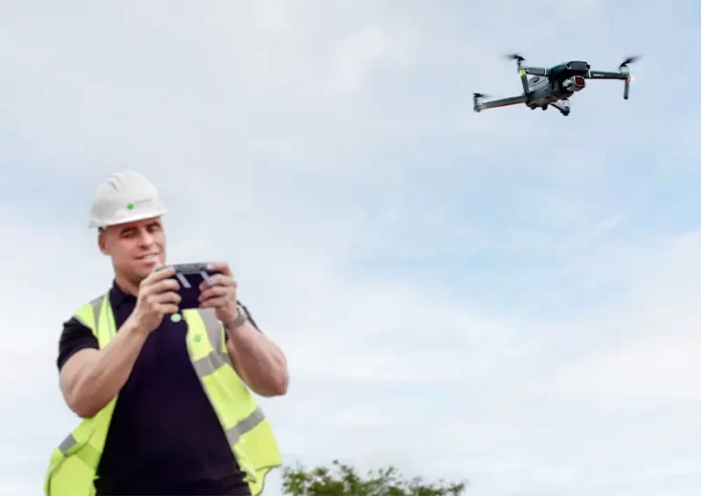 Construction worker operating a drone for roof survey, showcasing advanced drone technology for building inspections.