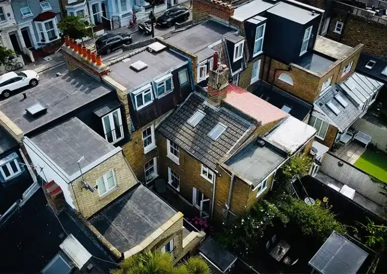Aerial view of a Victorian house showcasing its charming architectural features, including a sloped roof, chimney, and surrounding gardens, highlighting the blend of historic character and modern renovations by Environ Restoration Services.